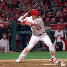 A baseball batter taking a swing at home plate