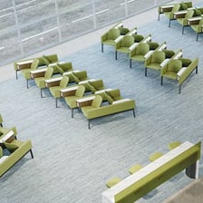 An airport departure gate with seating and a boarding entrance.