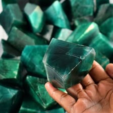 Several polished green emerald gemstones