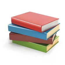 Several piles of books stacked together.