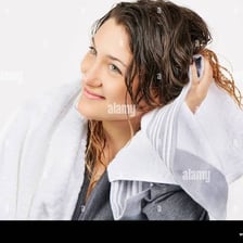 A person drying their hair with a towel.