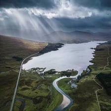 A camera-equipped drone flying above a landscape