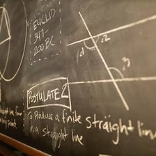 Mathematical statements written on a classroom blackboard