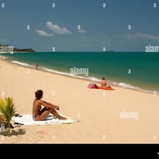 A beach shoreline associated with topless sunbathing