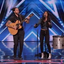 Two performers playing music together on a stage