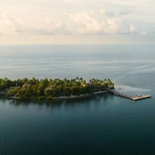 A small tropical island surrounded by shallow water