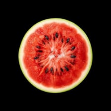 A cut watermelon with visible dark seeds