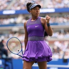 Naomi Osaka holding or playing with a tennis racket