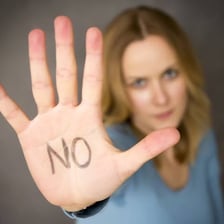 A person gesturing no in refusal