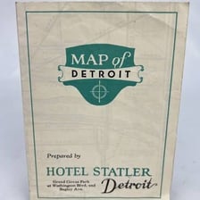 A folded local area map displayed at a hotel information desk