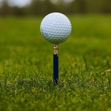 A golf ball resting on a tee before a shot