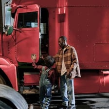 A truck driver operating a large semi-truck