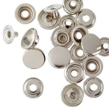 Metal snap fasteners used on clothing instead of a zipper.
