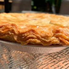 A close-up of a flaky baked pie crust.