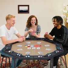 A poker player folding a hand at a card table