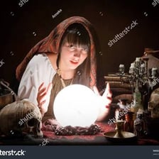 A fortune teller looking at a crystal ball.