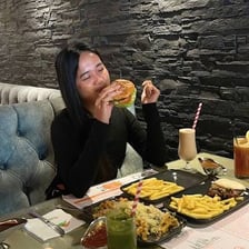 A person inspecting a meal carefully before eating it