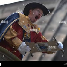 A costumed town crier announcing news in a colonial-era setting