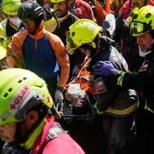 A rescuer helping a person out of danger and into safety.