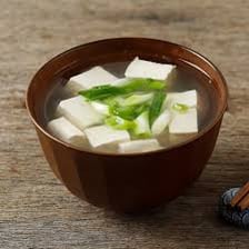 A bowl of Japanese miso soup with tofu and seaweed