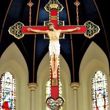 A large crucifix displayed inside a cathedral.