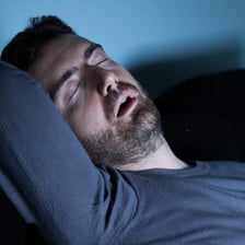 A sleeping person making a snoring noise.