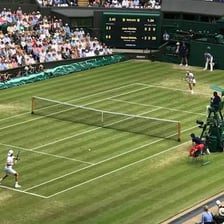Tennis players competing in a Wimbledon final on Centre Court.