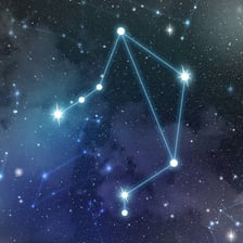The Libra zodiac symbol represented by a set of scales.