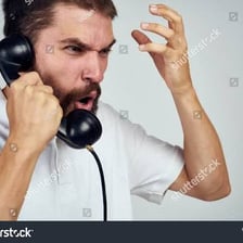 Person speaking into a telephone handset