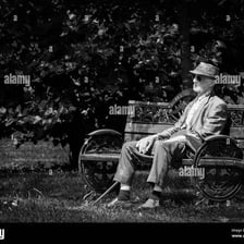 A person sitting alone on a bench.