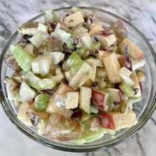 A serving of Waldorf salad containing diced apple pieces