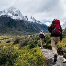 Hikers traveling along a challenging mountain trail.
