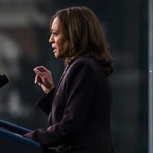 A person delivering a brief concession speech after losing an election
