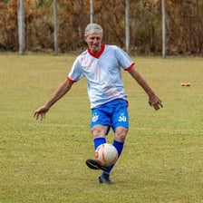 A person kicking a soccer ball
