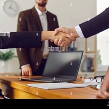 People shaking hands during a business deal.