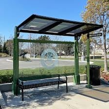 A city bus stopped beside a marked bus stop.