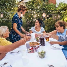 Party hosts welcoming guests at a social gathering.