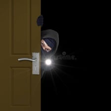 A person moving quietly and furtively through a doorway.