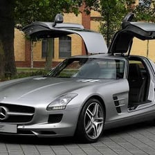 A Mercedes-Benz SLS AMG sports car with its distinctive gullwing doors.