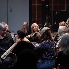 Musicians making a loud, chaotic mixture of sounds.