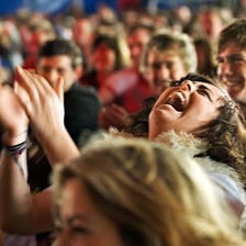 An audience laughing during a comedy performance