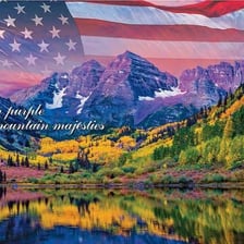 An American flag displayed against an expansive landscape