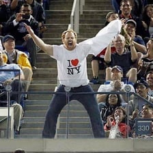 An enthusiastic fan cheering at a sporting event.