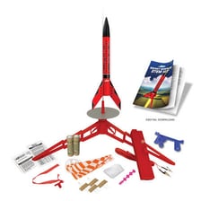 A classroom display featuring a model rocket and science materials