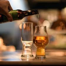 A glass of IPA craft beer being poured