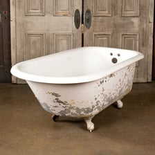 Vintage bathtubs standing on decorative claw-shaped feet.
