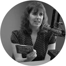 A person speaking into a microphone, illustrating a regional accent.