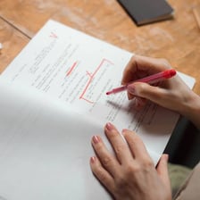 A document being revised with visible written edits.