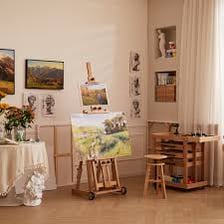 Several easels holding canvases in an art studio