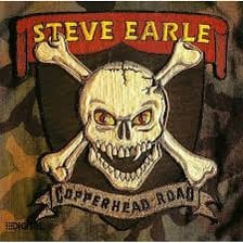 Steve Earle performing with a guitar